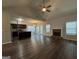 Bright, open-concept living space with vaulted ceilings, fireplace, hardwood floors, and seamless flow to kitchen and dining at 6703 Biscayne Blvd, Rex, GA 30273