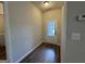 Practical mud room with hardwood floors, offering convenient access to the laundry area and back door at 6703 Biscayne Blvd, Rex, GA 30273