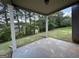 Covered patio featuring concrete flooring and view of the lush green backyard and woods at 6703 Biscayne Blvd, Rex, GA 30273
