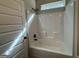 Bathroom shower with a bathtub and a white shower wall at 6703 Biscayne Blvd, Rex, GA 30273