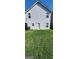 Large grassy backyard viewed from behind the house at 1562 Onalee Dr, Hampton, GA 30228