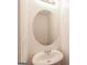 Powder room featuring a pedestal sink and round mirror at 1562 Onalee Dr, Hampton, GA 30228