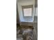 Well-lit bathroom features a sizable soaking tub with a window, and neutral-toned flooring and decor at 1562 Onalee Dr, Hampton, GA 30228