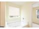Bright bathroom features a soaking tub with a large window and views of the exterior at 1562 Onalee Dr, Hampton, GA 30228
