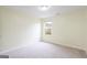 Neutral-toned bedroom features carpeted floors, a window with exterior view, and neutral paint at 1562 Onalee Dr, Hampton, GA 30228