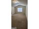 Expansive bedroom with neutral carpeting, complemented by a vaulted ceiling and a bright window at 1562 Onalee Dr, Hampton, GA 30228