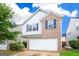 Two-story home featuring a brick and siding exterior, two-car garage, and manicured landscaping at 1562 Onalee Dr, Hampton, GA 30228