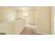 Bright upstairs hallway with carpet, window, and white railing at 1562 Onalee Dr, Hampton, GA 30228