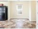 Spacious eat-in kitchen area with black refrigerator, tile floors, and window at 1562 Onalee Dr, Hampton, GA 30228