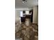 The spacious kitchen features dark cabinets, an island, and vinyl flooring that connect to the living area at 1562 Onalee Dr, Hampton, GA 30228