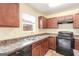 Well-lit kitchen features matching appliances, double basin sink beneath window, and ample counter space at 1562 Onalee Dr, Hampton, GA 30228