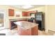 Kitchen with matching appliances and cabinets, tile floor, and island with countertop at 1562 Onalee Dr, Hampton, GA 30228