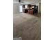 The carpeted living room connects to a modern kitchen with dark wood cabinets and an island at 1562 Onalee Dr, Hampton, GA 30228