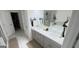 Dual sink bathroom vanity featuring marble floors, modern lighting, and plenty of counter space at 2282 Mclean Chase Se, Smyrna, GA 30080