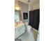 A simple bathroom featuring a vanity, toilet, and shower with a dark curtain at 2282 Mclean Chase Se, Smyrna, GA 30080