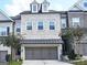 Charming townhome featuring a two-car garage, brick facade, and symmetrical window design at 2282 Mclean Chase Se, Smyrna, GA 30080