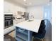 Kitchen with a large island, seating, white cabinets, and stainless steel appliances at 2282 Mclean Chase Se, Smyrna, GA 30080