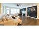 Comfortable living room featuring fireplace, TV, large windows and sectional sofa at 2282 Mclean Chase Se, Smyrna, GA 30080