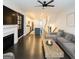 Open-concept living room with gray sofa, fireplace, and modern kitchen at 2282 Mclean Chase Se, Smyrna, GA 30080