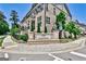 Brick townhomes at Park at Paces Ferry with lush landscaping on a tree-lined street at 2282 Mclean Chase Se, Smyrna, GA 30080
