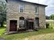 Close up of the stone house front with a small covered porch entry at 1085 Pleasant Hill Nw Rd, Conyers, GA 30012