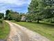 Exterior view of house set back from the road and surrounded by mature trees at 1085 Pleasant Hill Nw Rd, Conyers, GA 30012