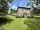 Stone house with a lush green lawn and mature trees around the property at 1085 Pleasant Hill Nw Rd, Conyers, GA 30012
