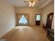 Neutral living room featuring carpet, window with curtains, and ceiling fan at 1085 Pleasant Hill Nw Rd, Conyers, GA 30012