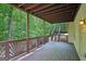 Expansive deck with wood railings, surrounded by lush greenery and offering serene outdoor living space at 765 Brooks Cir, Stone Mountain, GA 30087