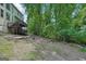 Green backyard with multi-level deck, landscaping and stairs leading up to home at 765 Brooks Cir, Stone Mountain, GA 30087