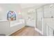 A bright bathroom featuring a soaking tub, vanity, and a glass enclosed shower at 765 Brooks Cir, Stone Mountain, GA 30087