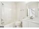 Clean bathroom with a shower-tub combo, bright white fixtures, and a vanity at 765 Brooks Cir, Stone Mountain, GA 30087