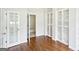 Stylish room featuring gleaming hardwood floors, built-in bookshelves and a closet at 765 Brooks Cir, Stone Mountain, GA 30087
