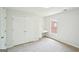 Bedroom with plush carpet, built-in desk, window and closet with double doors at 765 Brooks Cir, Stone Mountain, GA 30087
