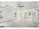 Bright bedroom with tray ceilings, neutral paint and carpet, and built in shelves at 765 Brooks Cir, Stone Mountain, GA 30087