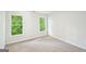 Bright, carpeted bedroom with neutral walls, large windows and exterior view at 765 Brooks Cir, Stone Mountain, GA 30087