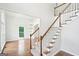 Bright foyer with hardwood floors, carpeted staircase, and an open view to the living area at 765 Brooks Cir, Stone Mountain, GA 30087