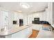 Kitchen featuring white cabinets, an island, stainless appliances, and breakfast bar at 765 Brooks Cir, Stone Mountain, GA 30087