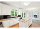 Spacious kitchen with white cabinets, a center island, and black appliances at 765 Brooks Cir, Stone Mountain, GA 30087
