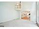 Open-concept living room with neutral carpet, and view of the white kitchen with island at 765 Brooks Cir, Stone Mountain, GA 30087