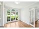 Sunlit room with hardwood floors, built-in shelves, and arched windows showcasing a beautiful neighborhood view at 765 Brooks Cir, Stone Mountain, GA 30087