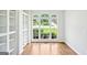 Bright living room with built-in shelving, hardwood floors, and large windows offering neighborhood views at 765 Brooks Cir, Stone Mountain, GA 30087