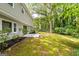 Backyard featuring a patio surrounded by mature trees and greenery at 335 Cedar Ln, Fayetteville, GA 30214