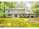 Wide shot of backyard featuring a lawn, mature trees, and the back of the home at 335 Cedar Ln, Fayetteville, GA 30214