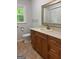 Cozy bathroom featuring classic vanity, decorative mirror, and ample natural light, creating a serene retreat at 335 Cedar Ln, Fayetteville, GA 30214