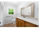 Bathroom with neutral colors, a framed mirror, and a wood vanity at 335 Cedar Ln, Fayetteville, GA 30214