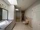 Bathroom featuring a shower with glass door, sink, and toilet at 335 Cedar Ln, Fayetteville, GA 30214