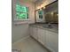 Bathroom featuring a window, mirror, and sink at 335 Cedar Ln, Fayetteville, GA 30214