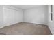 Neutral bedroom boasts a large closet with double doors and light beige carpeting at 335 Cedar Ln, Fayetteville, GA 30214