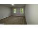 This spacious bedroom features two windows that let in natural light, creating a comfortable environment at 335 Cedar Ln, Fayetteville, GA 30214